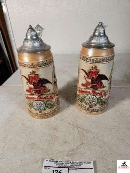 (2) ANHEUSER-BUSCH, INC. KING OF BEERS STEIN "K" SERIES #20252 "THIS LIMITED EDITION STEIN ILLUSTRATES THE TAVERN AND PPUBLIC HOUSE TRADITION OF THE 17TH CENTURY." - "M" SERIES #40829 "THIS LIMITED EDITION STEIN ILLUSTRATES THE SPECIAL TIES TO THE BAVARIAN FESTIVAL TRADITION." - (UPSTAIRS) image