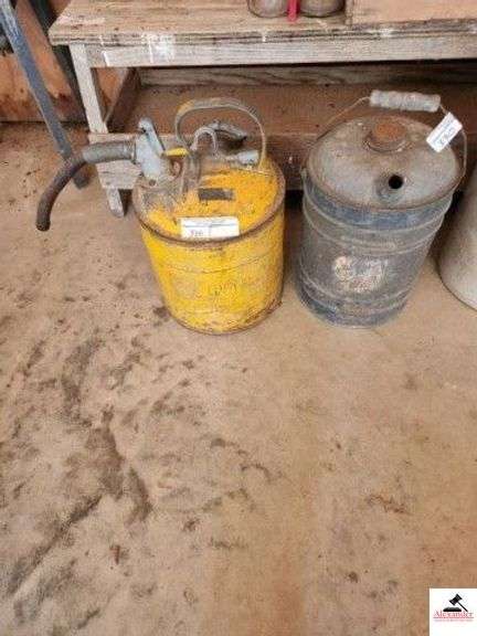 VINTAGE YELLOW SAFETY GAS CAN APPROVED BY UNDERWRITER LAB INC 8344L86 - HAS GOVERNMENT STAMPED ON IT - PAINT IS WORN - SHOWS SOME RUST AND DENTS - INCLUDES GALVANIZED OIL CAN - SHOWS SOME USE WEAR AND ONE OF THE TOPS IS MISSING - (GARAGE) image