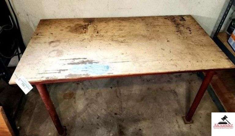 WORK SHOP TABLE PLYWOOD TOP WITH PIPE LEGS - TOP IS WORN - 52" WIDE X 26 1/2" DEEP X 28" TALL - NO INVENTORY INCLUDED - TABLE ONLY - (SHOP) image