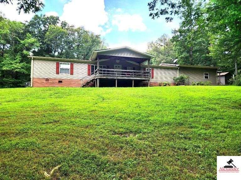 TRACT 1:  RESIDENCE - 1.848 SQ. FT.  & 15.72+/- ACRES - MAIN RESIDENCE - GREAT ROOM - 2 BATHS - MASTER BEDROOM & PRIVATE BATH - ATTACHED GARAGE - GENTLY ROLLING LAND WITH SHADE TREES & TIMBER - GOOD HUNTING - SHOP 24 FT. X 30 FT. - GARAGE 12 FT. X 12 FT. - IMPLEMENT BARN 47 FT. X 27 FT. image