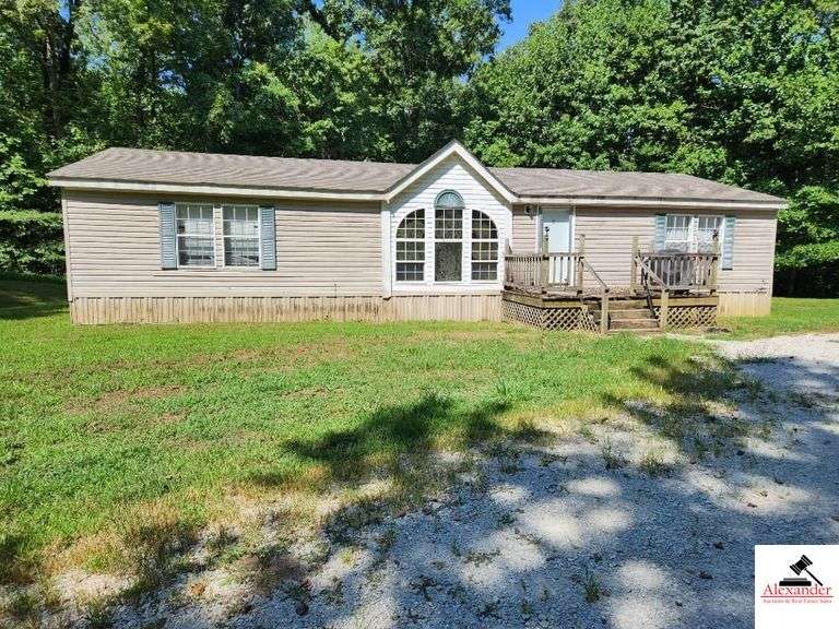 TRACT 2:  SECOND RESIDENCE & 8+/- ACRES - GREAT ROOM WITH TRIPLE WINDOWS - KITCHEN & DINING COMBINATION WITH ROCK BAR - APPLIANCES - MASTER BEDROOM WITH CORNER TUB & WALK-IN SHOWER  - 2 ADDITIONAL BEDROOMS - 2ND BATH - UTILITY - DETACHED METAL CARPORT - LEVEL TO GENTLY ROLLING ACRES IN GROWING TIMBER - GOOD DEER HUNTING image