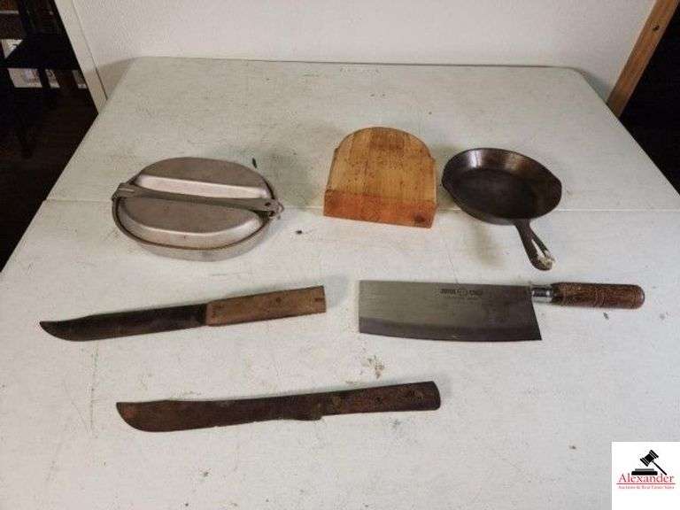 JOYCE CHEN STAINLESS STEEL MEAT CLEAVER ARMY US REGAL 1966 DSA-4-0A2661-TR530 MESS KIT - 6 1/2 IN IRON SKILLET - WOOD CHOPPING BLOCK - 2 VINTAGE BUTCHER KNIVES - ONE HAS HANDLE MISSING - KEEN CUTTER FOOD CHOPPER - US COTTON DUCK DUFFEL BAG - HAS A FEW HOLES - ALUMINUM ARMY COT -  (UPSTAIRS) image