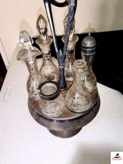 ANTIQUE SILVERPLATE CRUET CASTOR SET (6) BOTTLES 3 WITH GLASS STOPPERS - SOME STOPPERS ARE CHIPPED - TWO METAL CAPS ARE MISSING - VICTORIAN SILVER CONDIMENT TRAY - CRUET BOTTLES ARE ETCHED GLASS - (UPSTAIRS) image