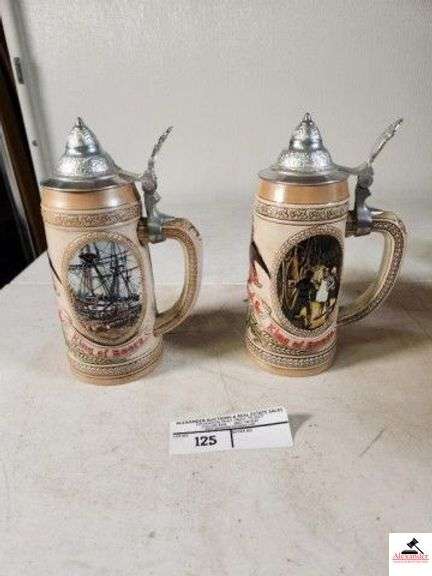 (2) ANHEUSER-BUSCH, INC. KING OF BEERS STEIN "G" SERIES #85506 "THIS LIMITED EDITION STEIN ILLUSTRATES EARLY TRANSPORTATION VIA RAIL DEPOT AND MERCHANT SHIP IN AN EARLIER TIME." - "D" SERIES #29679 "THIS LIMITED EDITION STEIN ILLUSTRATES THE AGING AND COOPERAGE PROCESS FROM THE 17TH CENTURY." - (UPSTAIRS) image