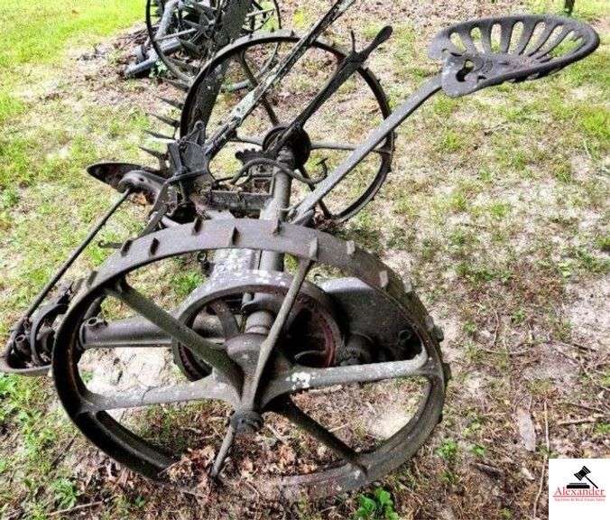 HORSE DRAWN SICKLE MOWER MCCORMICK CHICAGO USE - CLEAT WHEELS - IRON SEAT - ONE SPOKE MISSING - SICKLE BAR NO BLADE - WOOD HANDLE DETERIORATED - (OUTSIDE) image