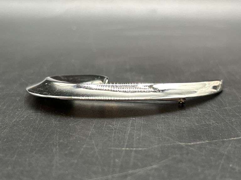 Chrome finish spiral swoosh brooch