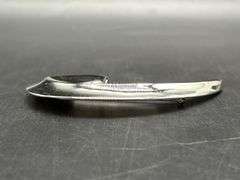 Chrome finish spiral swoosh brooch