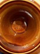 Emile Henry France (6180) high glaze ceramic pedestal cake plate with scalloped inner design