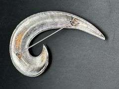 Chrome finish spiral swoosh brooch