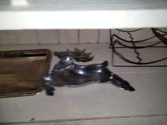 Items in cabinet: plastic red ware, Krups, reindeer tray and more