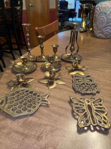Grouping of brass candle holders and trivets image