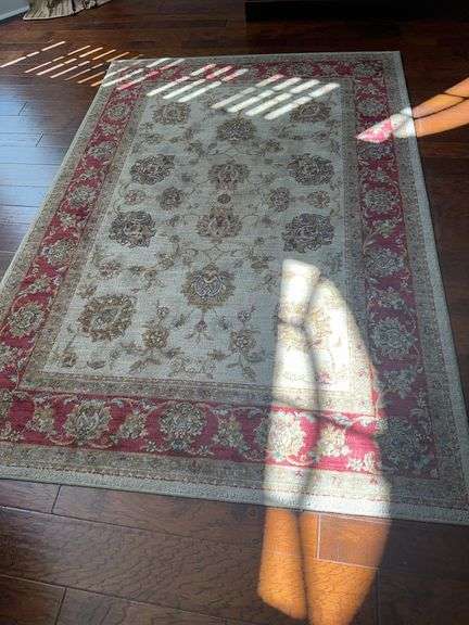 Area rug in colors of gold tan, and red image