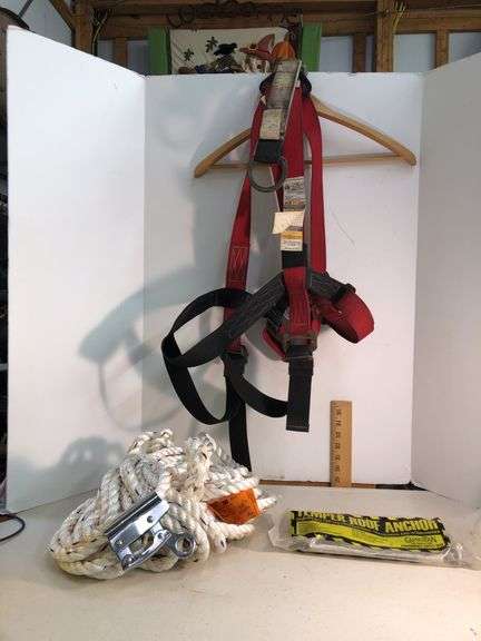 Fall protection equipment. New 3M rope, new Guardian roof anchor and used harness. Metal pieces on the harness are rusty. image