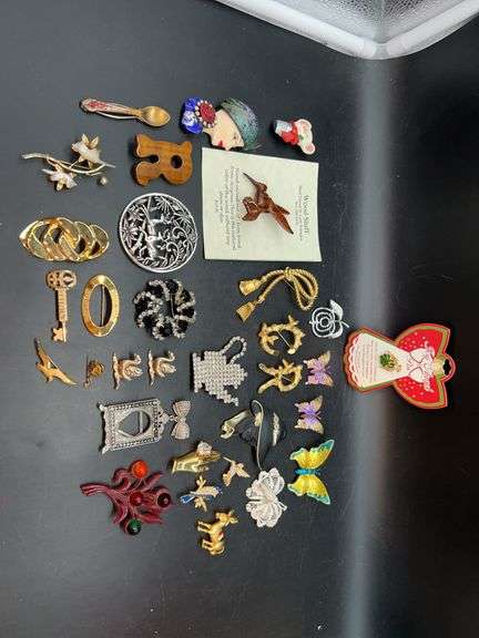 Vast assortment of vintage and modern brooches image