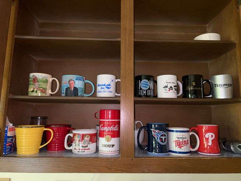 Contents of kitchen cabinet…..Campbells Soup memorabilia, Starbucks cast enamel mugs, sports mugs and more image