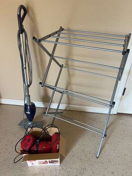 Cleaning Essentials and Clothing Rack image