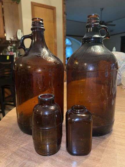Grouping of (4) amber color jars…..(2) are apothecary and (2) are gallon jugs image