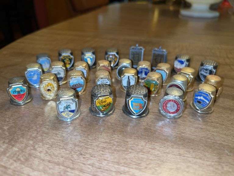 Grouping of gold and silver tone collectible thimbles image