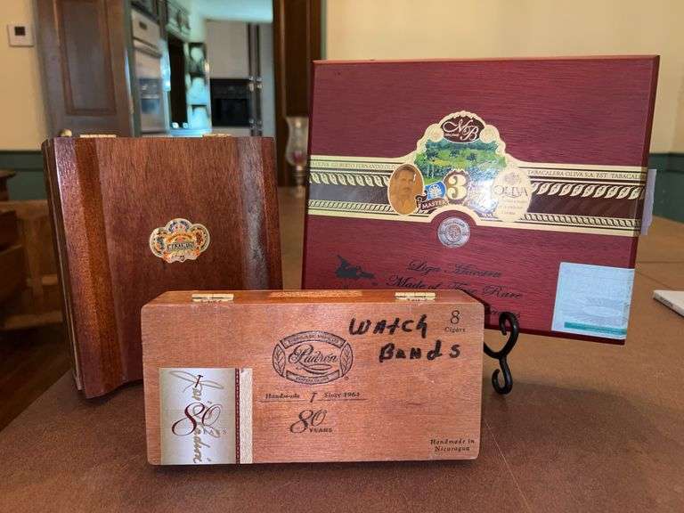 3 nice looking wooden cigar boxes (one has writing “watch bands” image