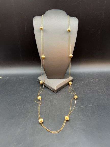 Elegant gold tone opera length necklace with ribbed cylindricals……can be doubled or more for shorter length image