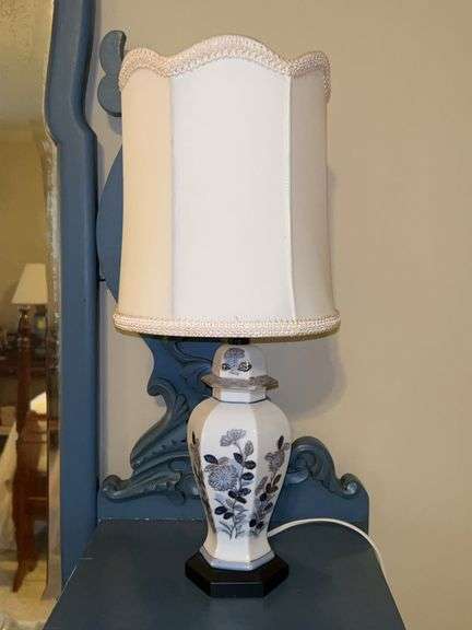 Chinoiserie-style lamp, often referred to as a ginger jar lamp featuring a blue and white floral pattern and elegant scalloped edge shade…..working condition…..￼19” tall image