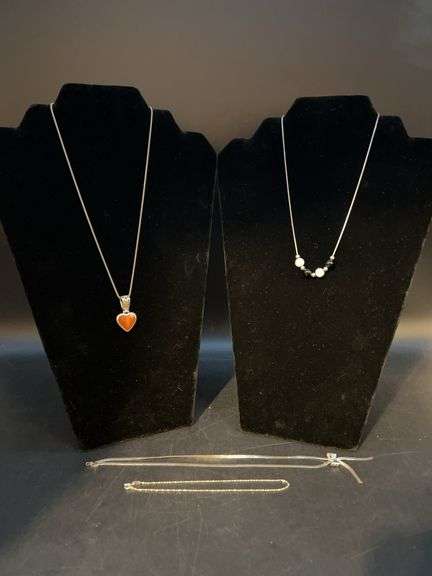 (4) pieces of sterling jewelry…..from left - both chain and pendant are sterling (7 grams), chain is sterling with beautiful blue and white glass beads, chain with bow is sterling and clasp needs repaired (5 grams) and bracelet is too lightweight to weigh image