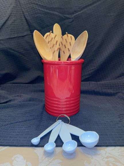 Red stoneware utensil crock, wooden utensils and set of Martha Stewart measuring spoons image