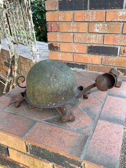 Great looking handcrafted turtle yard art constructed from an old military helmet and other metals image