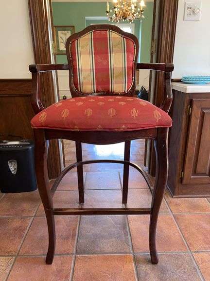 a Louis XV-style wooden bar stool with upholstered red and plaid/print fabric cushioned seat and back…..24 x 19 x 45-1/2 tall overall image