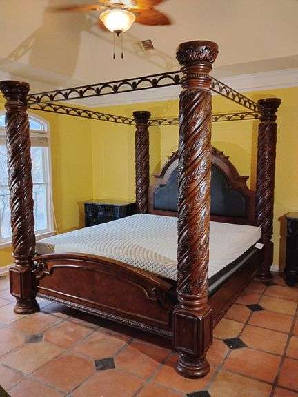 Ashley North Shore Dark Brown California King Poster Bed with Canopy, very ornate, B553-172, Mattress, Beautyrest Black Memory Foam with BLACK ICE on a LINAK adjustable mattress system platform underneath with remote. Dimensions 7' 6 3/4" T x 8' 5" L x 7' 2" W. Scratches on footboard and right side side rail, could be touched up with pen.  Located on second floor. This piece is very large and heavy and BUYER IS RESPONSIBLE FOR REMOVAL, will have to be maneuvered around staircase. image