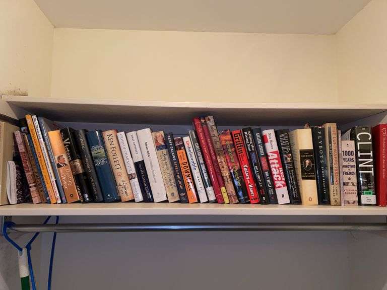 Shelf of books in bedroom closet image