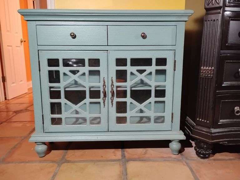 Coast to Coast Two Drawer Two Door Cupboard in distressed Teal finish. Good condition. Retails for $599.00. Located on 2nd floor. 36 1/2" T x 40" W x 12" D. Will have to be maneuvered around the staircase. BUYER IS RESPONSIBLE FOR REMOVAL. image