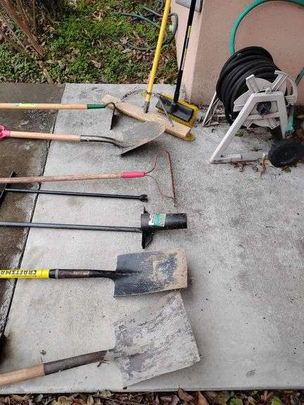 Selection 25' maybe 50' heavy Duty black rubber hose, water meter tool, bulb planter tool, hoe, 2 brooms, 3 shovels, 1 metal rake, used image