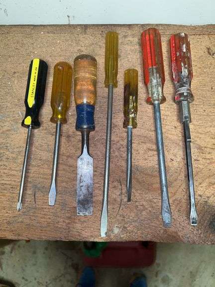 Grouping of screwdrivers and (2) chisel….includes small metal tool box image
