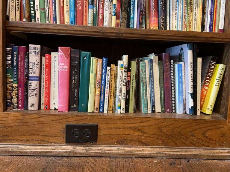 Bottom shelf of books…..mostly religious in nature image