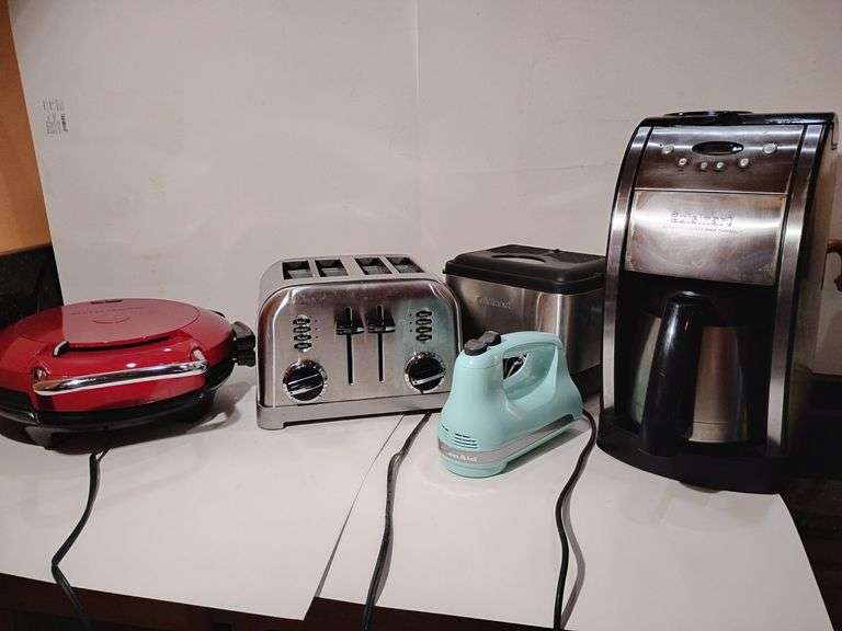 Group Small Appliances, George Foreman Grill, Cuisinart 4 slice toaster, Cuisinart Compact Deep Fryer, Kitchen Aid 5 speed hand mixer, missing mixing tongs, Cuisinart Automatic Grind & Brew Coffee Maker. All used, untested. image