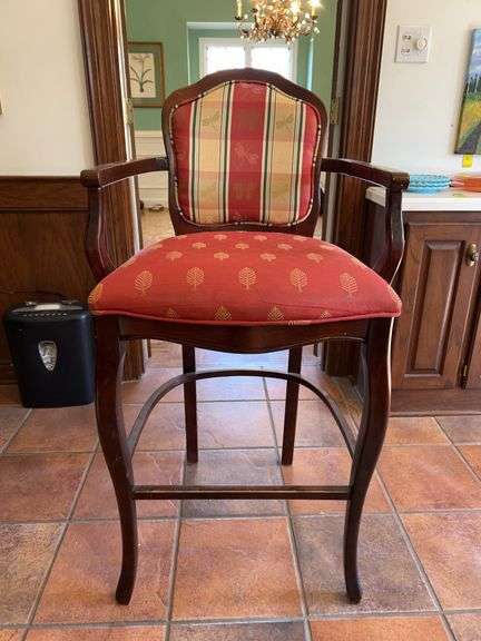 a Louis XV-style wooden bar stool with upholstered red and plaid/print fabric cushioned seat and back…..24 x 19 x 45-1/2 tall overall image