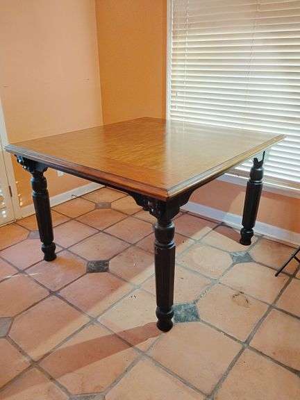 Farmhouse Style Tall Dining Table with turned legs. 36 1/4"T x 54 1/4"L x 57 3/4"W. Medium wood finish top, Black rubbed finish bottom & legs. There is a ring stain on top and scuffs on legs. Sturdy, solid wood. BUYER IS RESPONSIBLE FOR REMOVAL. image