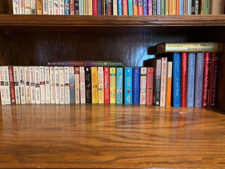Bottom shelf of books…..authors include Mary Daheim, Diane Mott Davidson, Jan Karon image