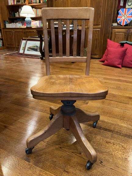 Vintage solid oak rolling office chair with a slatted back and saddle seat….16-1/4 x 14-1/2 x 34-1/2 tall overall image