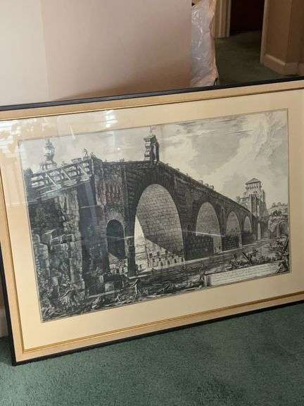 Framed etching of the Ponte Molle (also known as the Milvian Bridge or Ponte Milvio) over the Tiber River in Rome. This specific print is identified as "The Ponte Molle sul Tevere" from the series Vedute di Roma by the renowned Italian artist Giovanni Battista Piranesi, created in 1762 image
