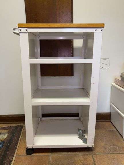 White metal 3-tiered rolling cart with butcher-block style top…..front right caster needs fixed….19-1/2 x 16 x 35 tall….both sides would accommodate pegs for hanging items image