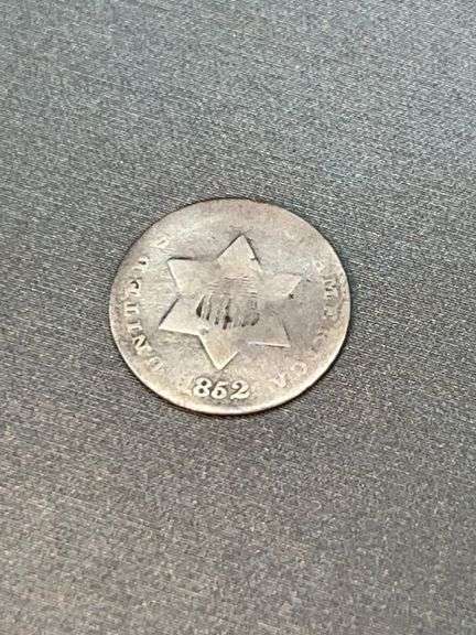 1852 Trime - a small, silver U.S. three-cent coin, known for its tiny size and nickname "fish scales," minted in Philadelphia as part of the first type of these coins image