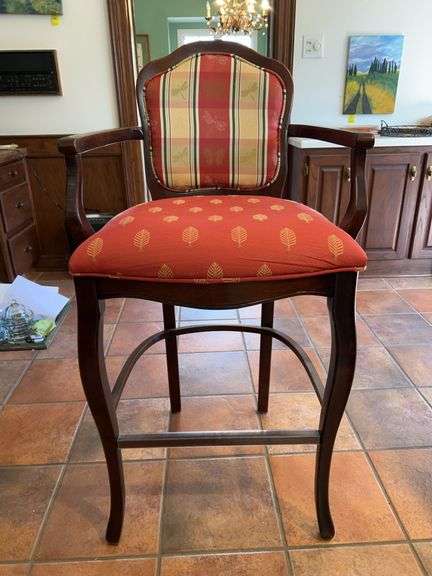 a Louis XV-style wooden bar stool with upholstered red and plaid/print fabric cushioned seat and back…..24 x 19 x 45-1/2 tall overall image