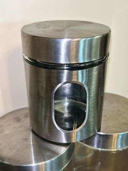 Set of (3) glass and stainless storage jars and (1) all stainless…..heights range from 9” down to 5”