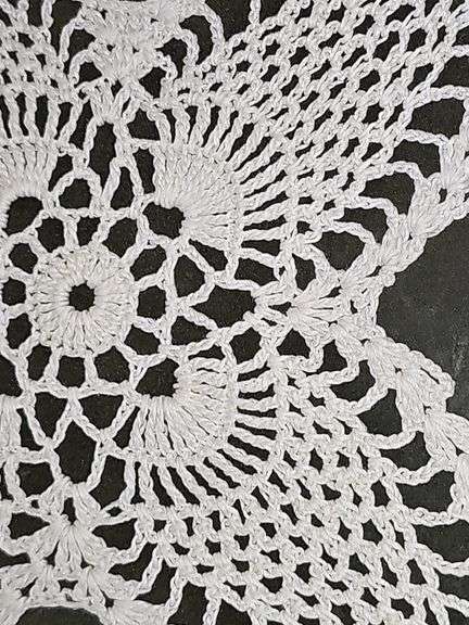 Framed hand crocheted doily. 13 x 13 in