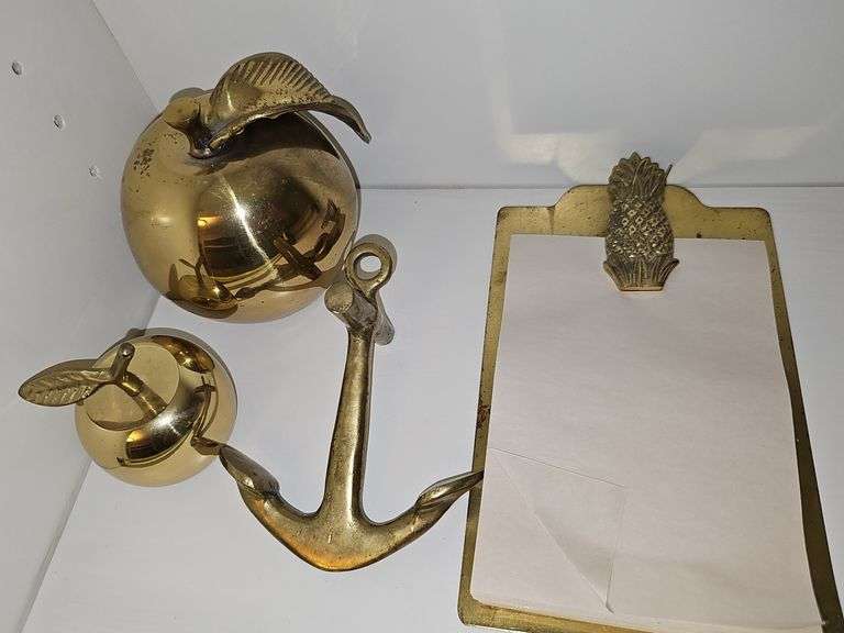 Grouping of brass items. Large apple, small apple, anchor, pineapple note holder.