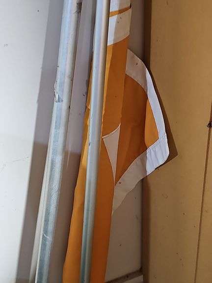 Three flag poles. One has a UT  flag. Silver poles are 72 in. UT is 48 in.