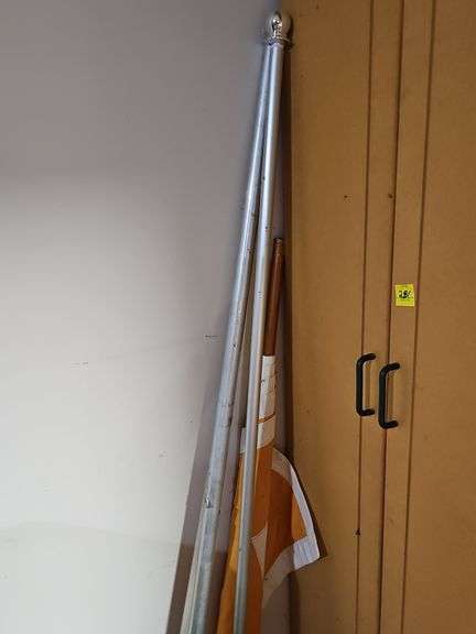 Three flag poles. One has a UT  flag. Silver poles are 72 in. UT is 48 in.