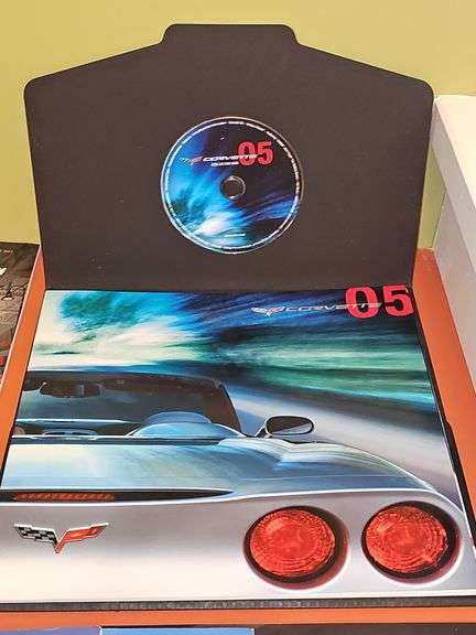 Grouping of Corvette dealership brochures, America sports car magazines, and new roads magazines.